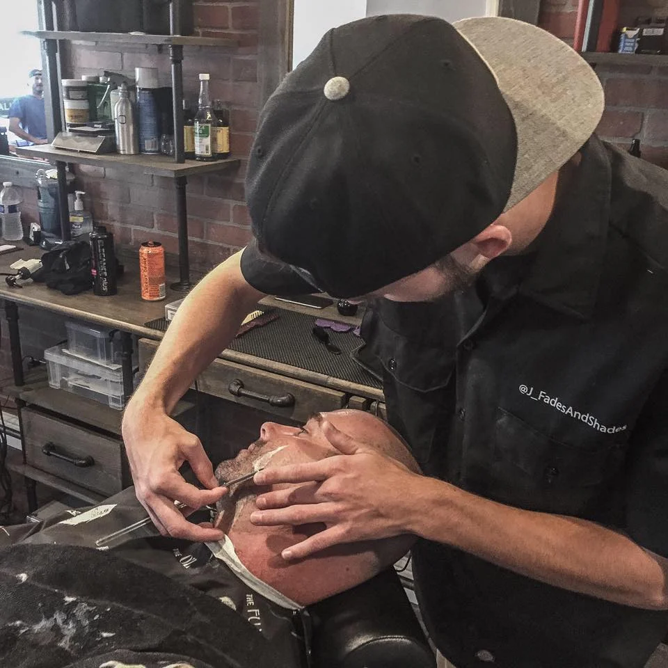 Barber giving a straight razor shave